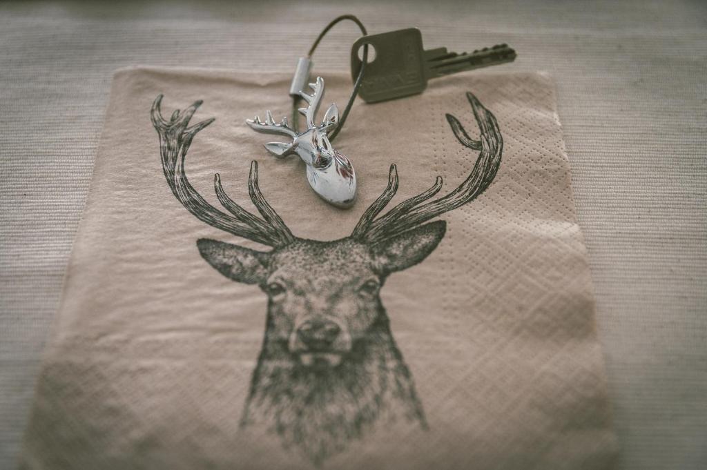 a drawing of a deer with antlers on a table at "Hunter's Suite"- at the heart of Hartberg I Parking in Hartberg