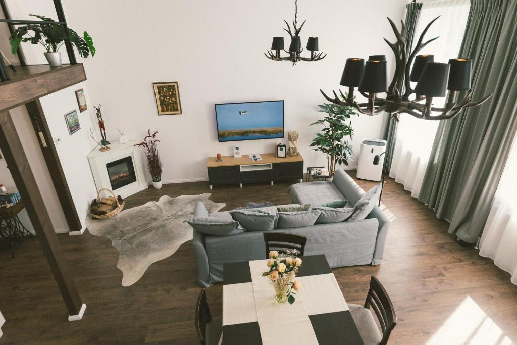 a living room with a couch and a tv at "Hunter's Suite"- at the heart of Hartberg I Parking in Hartberg