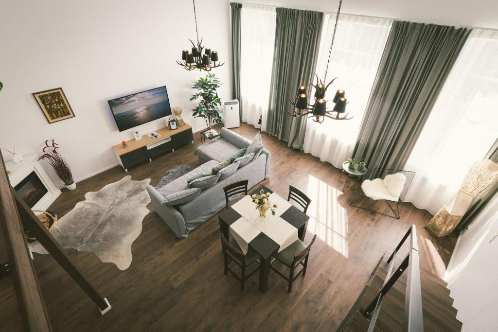 a living room with a couch and a table at "Hunter's Suite"- at the heart of Hartberg I Parking in Hartberg