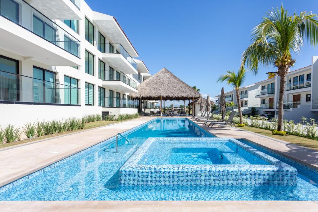 a swimming pool in front of a building at El Tigre Resort, Quinta San Miguel in Nuevo Vallarta 