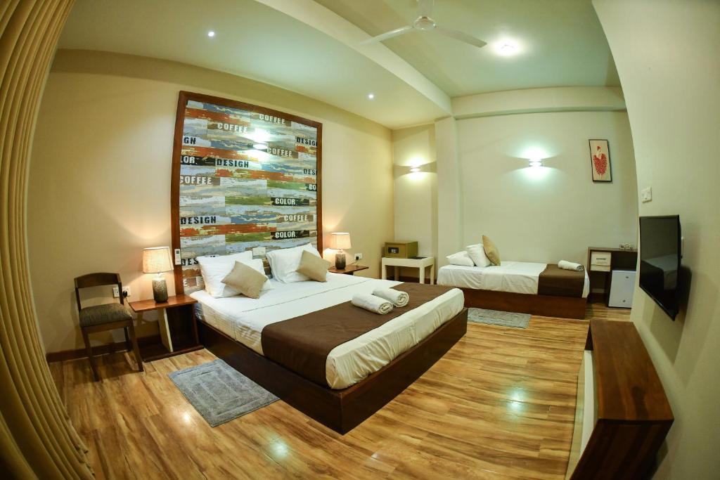 Postel nebo postele na pokoji v ubytování Hiriketiya Beach Resort