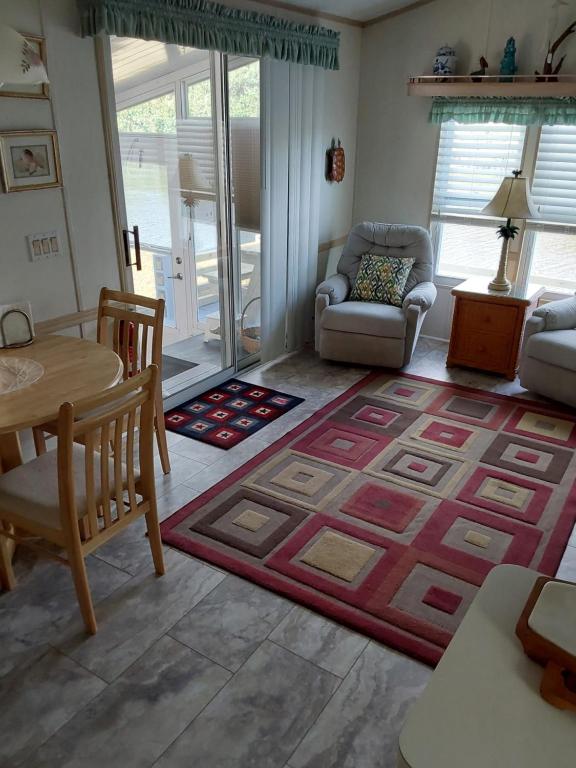 a living room with a table and a rug at holiday dream house in Port Charlotte