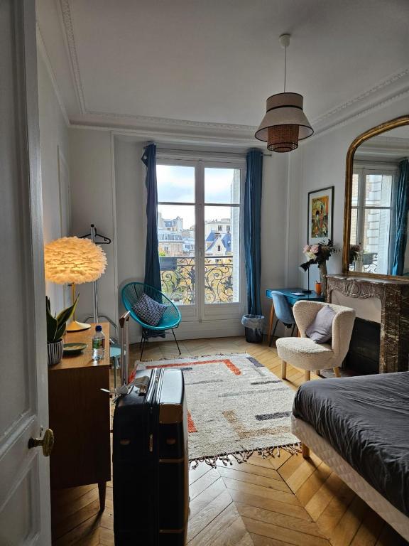 a room with a bed and a living room with a window at Cosy private room in Shared appartment - 1 person only ! in Paris