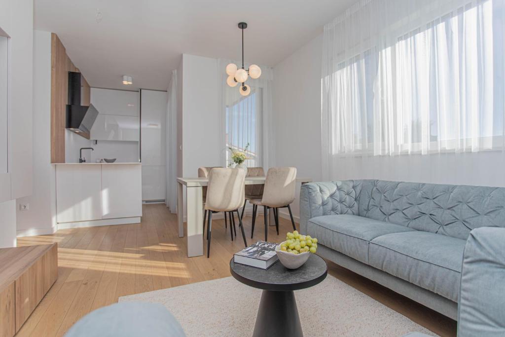 a living room with a couch and a table at Luxury Apartment Providenca with Private Rooftop Terrace in Podstrana