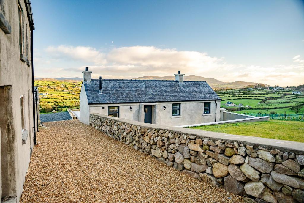a stone wall next to a stone house at Mc Leans in Newry