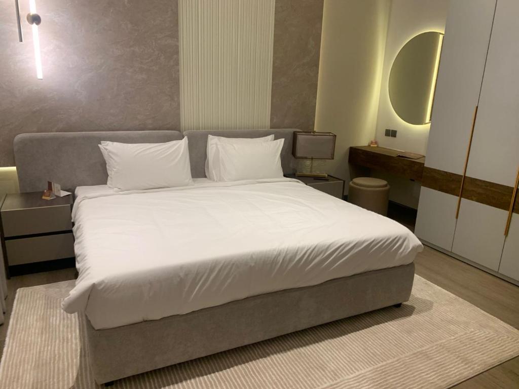 a bedroom with a large bed with white sheets and pillows at فندق ليورا Liora Hotel in Riyadh