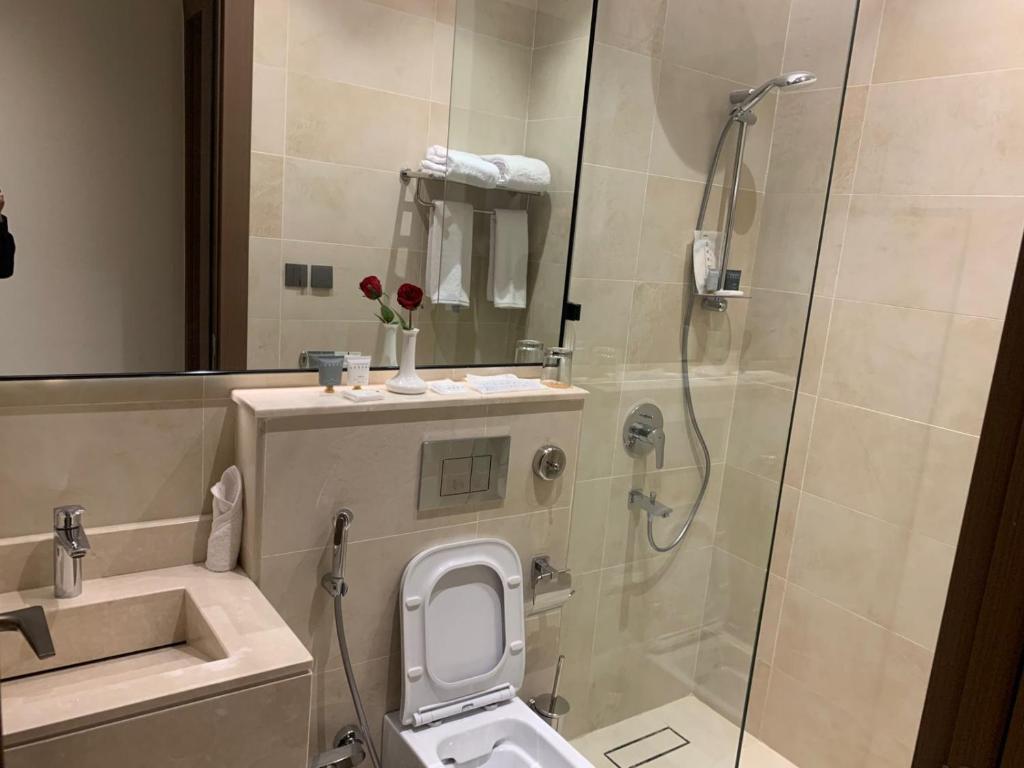 a bathroom with a shower and a toilet and a sink at فندق ليورا Liora Hotel in Riyadh