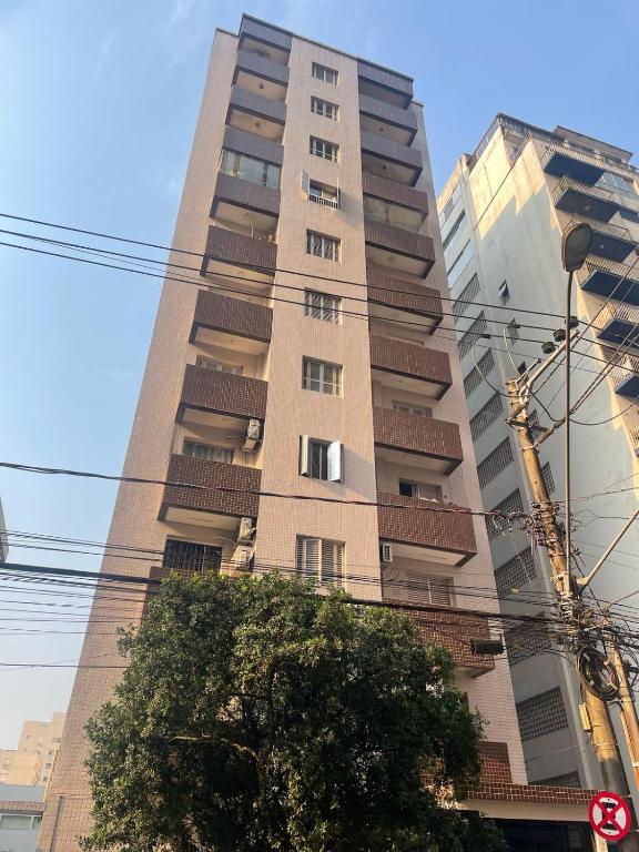 a tall building with a tree in front of it at salaliving 405 in São Vicente