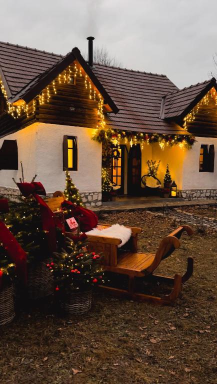 a house with christmas lights and a christmas tree in front of it at Cuib din Fagaras in Avrig