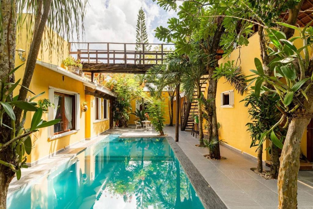 a swimming pool in the middle of a house with trees at Villa con piscina y acceso a laguna Yalku, Akumal in Akumal