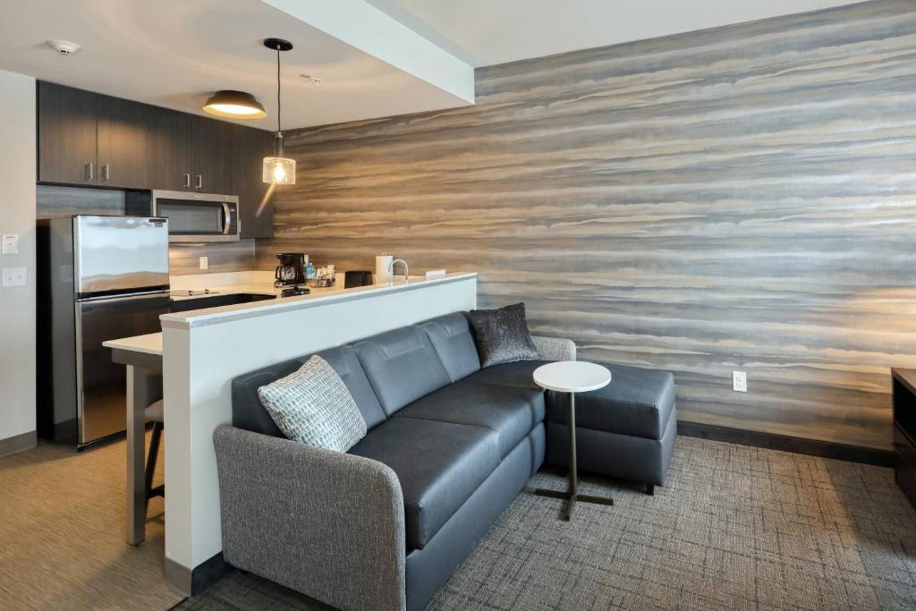 a living room with a couch and a kitchen at Residence Inn by Marriott Harrisburg North in Harrisburg