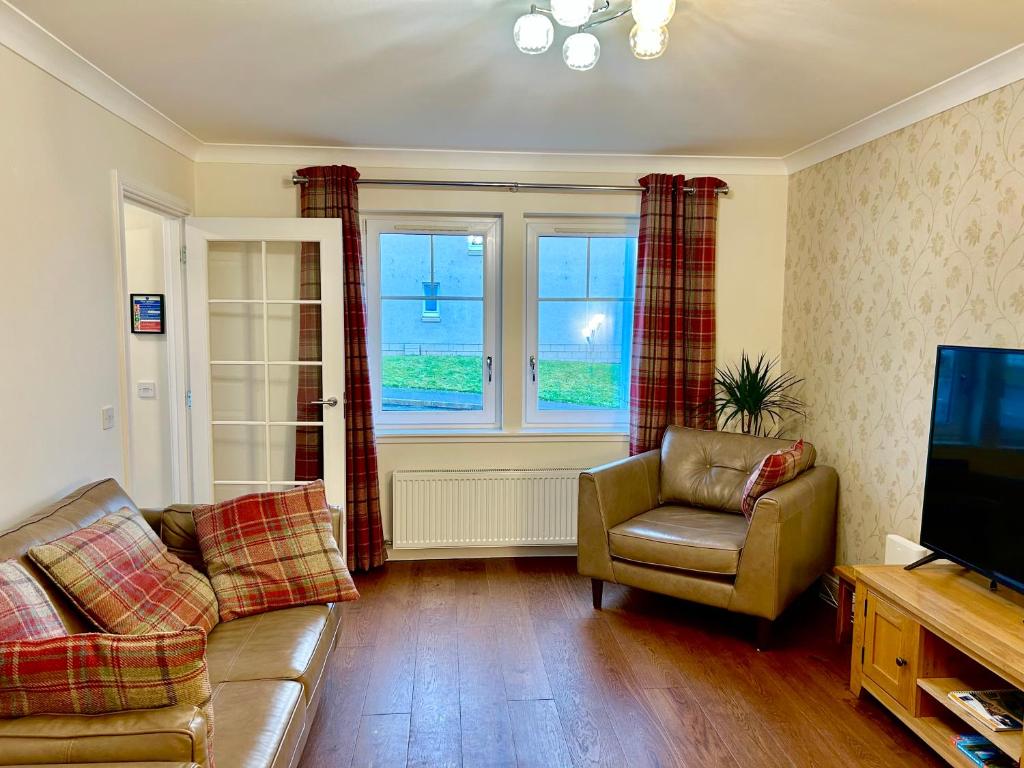 a living room with a couch and a television at Inverness Retreat in Inverness