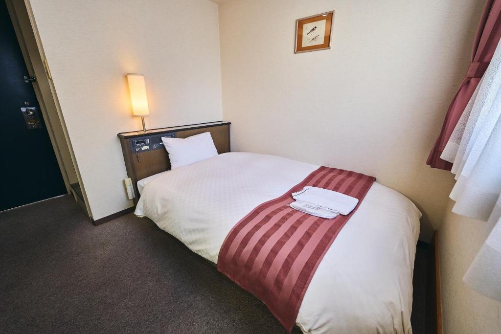 Postel nebo postele na pokoji v ubytování Hotel Astir Nagoya Sakae