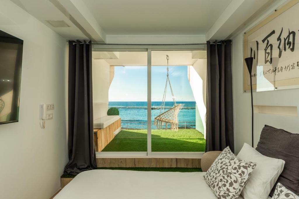 a bedroom with a bed and a view of the ocean at OceanSound White in Las Palmas de Gran Canaria