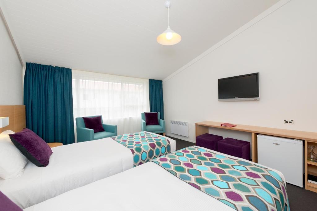 Postel nebo postele na pokoji v ubytování Heartland Hotel Fox Glacier