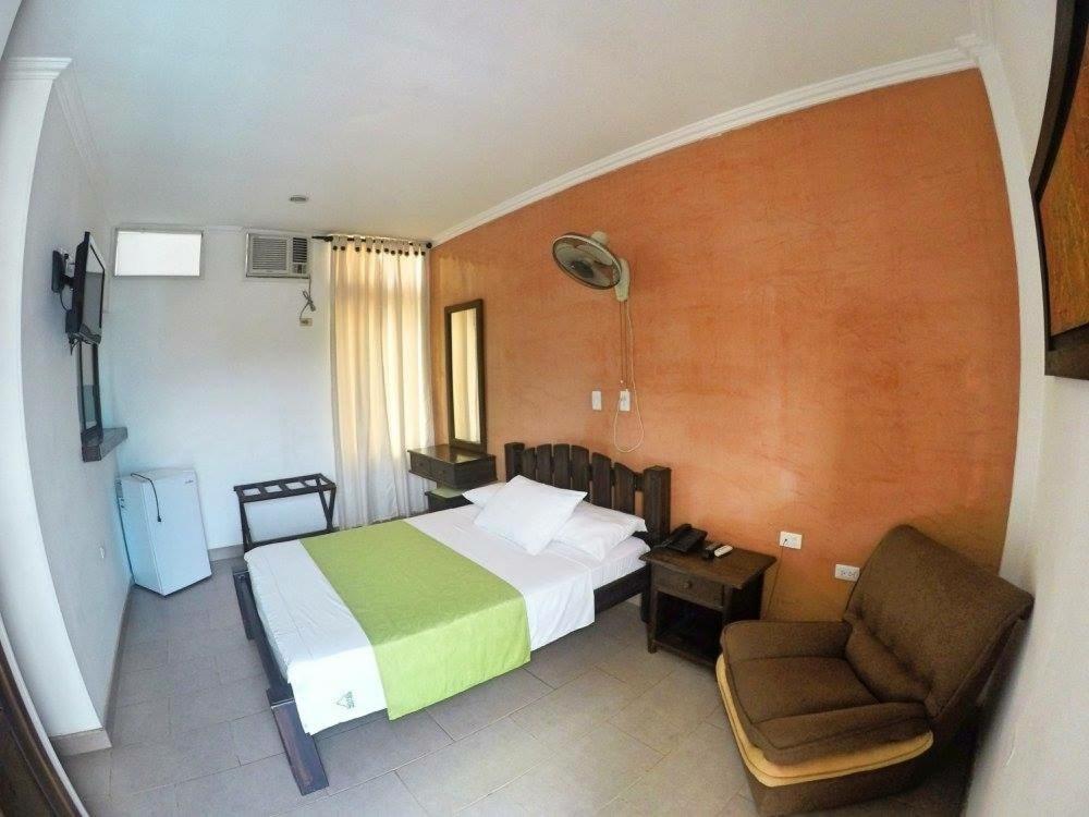Monteverde Hotel tesisinde bir odada yatak veya yataklar