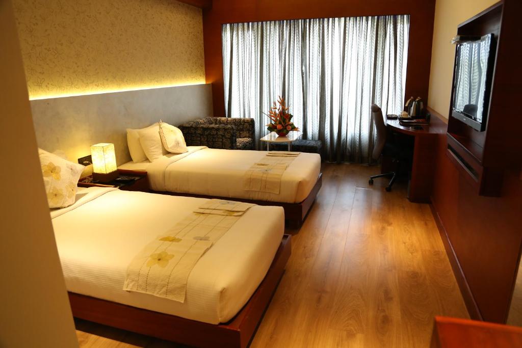 Postel nebo postele na pokoji v ubytování Diana Heights Luxury Hotel