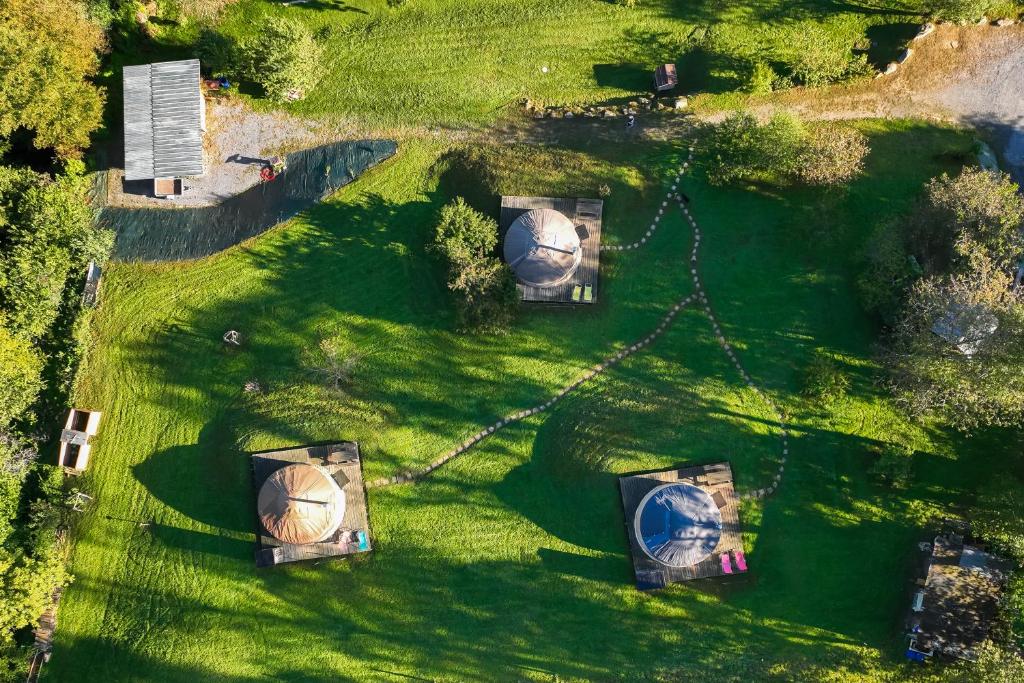 an overhead view of a garden with three domes at Yourtes Olachat proche Annecy in Faverges