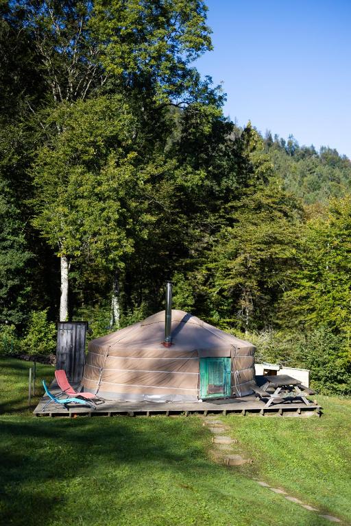 a tent in a field with trees in the background at Yourtes Olachat proche Annecy in Faverges