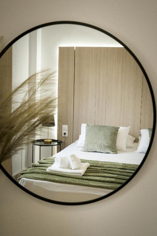 a mirror reflection of a bed in a bedroom at Marisa in Ierapetra