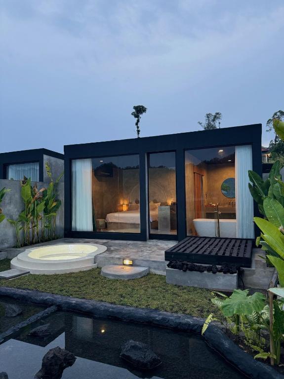 a modern house with a pool and a bedroom at La Varuna Kintamani and Hot Spring in Kintamani
