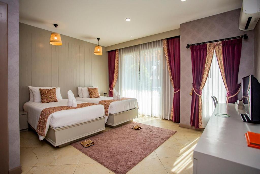 Postel nebo postele na pokoji v ubytování La Villa Boutique hotel