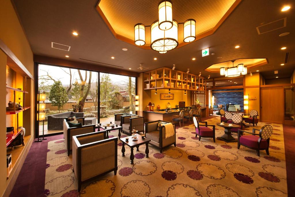 a large living room with couches and tables at Kanazawa Hyakurakusou in Kanazawa