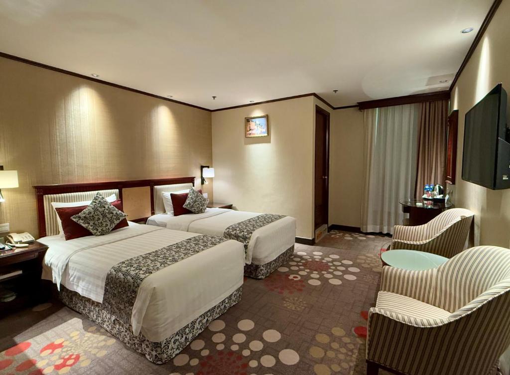 Postel nebo postele na pokoji v ubytování Macau Masters Hotel