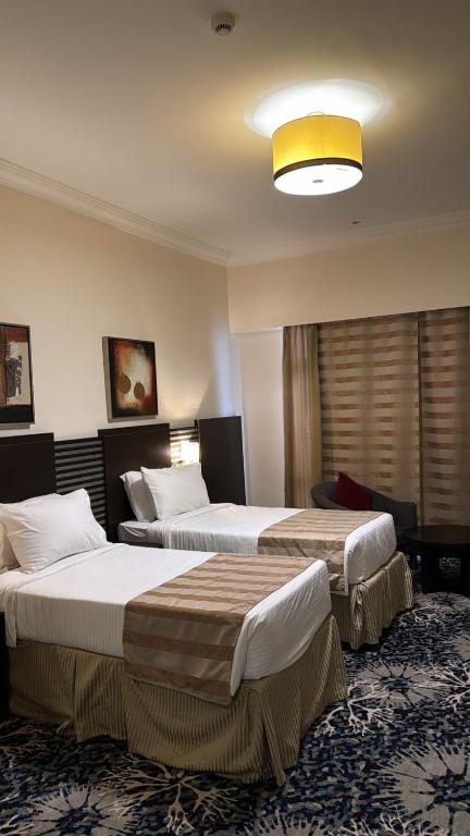 Postel nebo postele na pokoji v ubytování Al Hidayah Towers Hotel