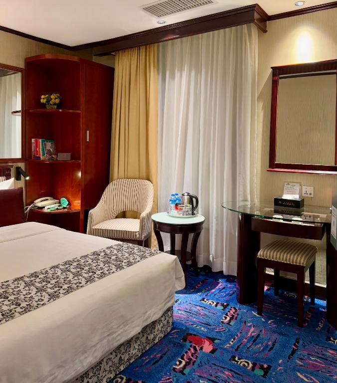 Postel nebo postele na pokoji v ubytování Macau Masters Hotel