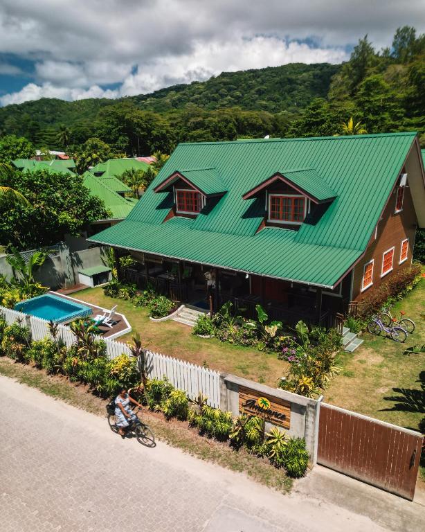 an overhead view of a house with a green roof at Ambiance Villa in La Digue