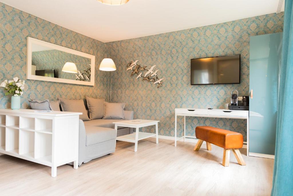 a living room with a couch and a table at Hus Mattgoot - Doppelzimmer No.2 in Böhl
