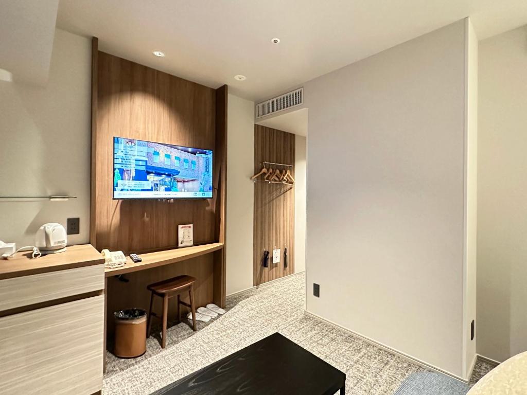 TV a/nebo společenská místnost v ubytování New Osaka Hotel