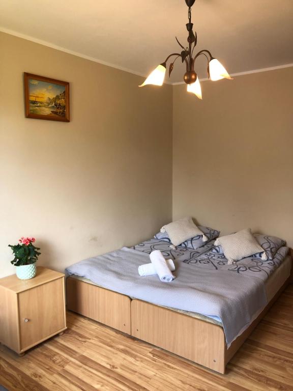 a bedroom with a bed with a stuffed animal on it at Pensjonat Klaudia in Ostrowo