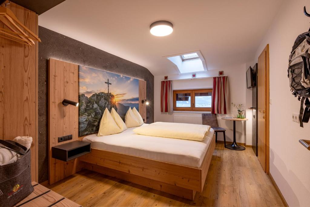 Postel nebo postele na pokoji v ubytování Das Sonnleiten Ski- und Motorradhotel Bruck im Zillertal