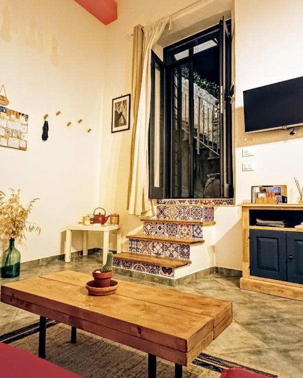 a living room with a coffee table and a window at La Casetta Nelle Mura in Terracina