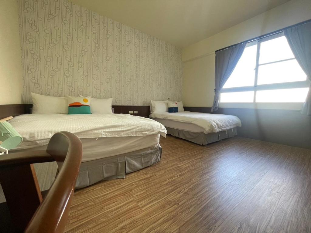 Postel nebo postele na pokoji v ubytování 回家浪