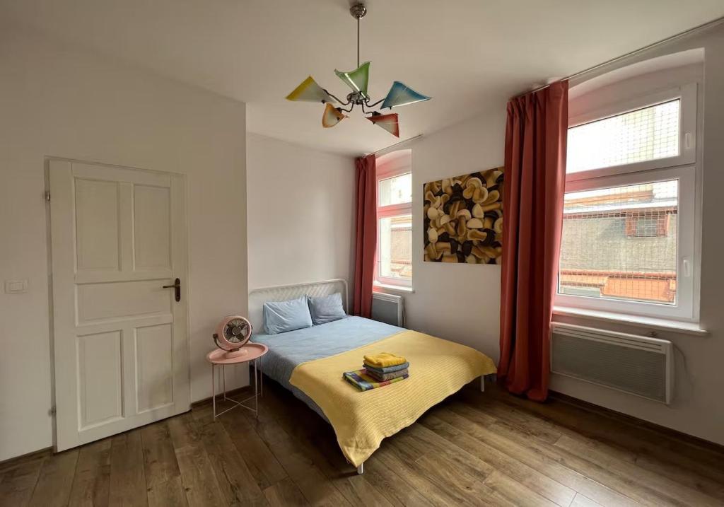 a bedroom with a bed and a window at Apartment Katowice Center - Słowackiego in Katowice