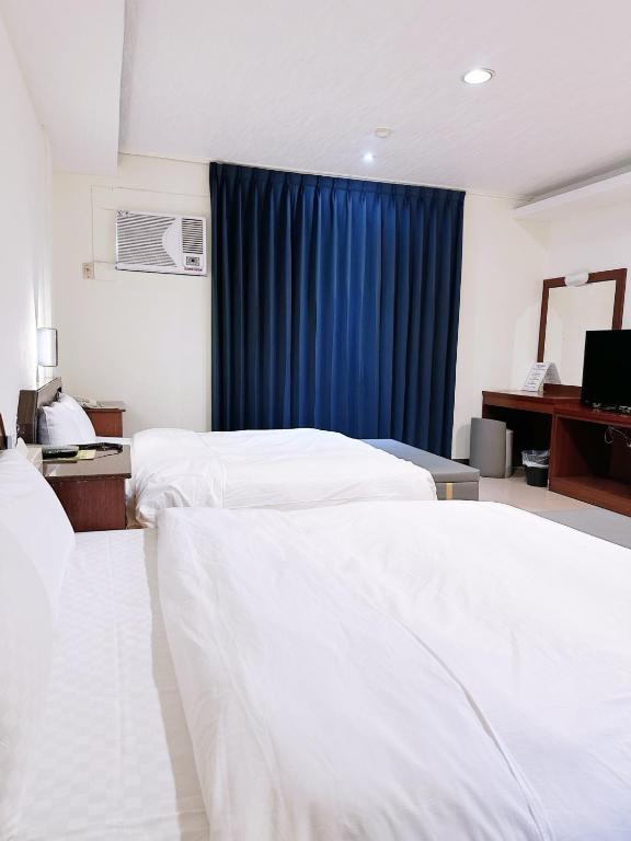 Postel nebo postele na pokoji v ubytování Hua Du Motel