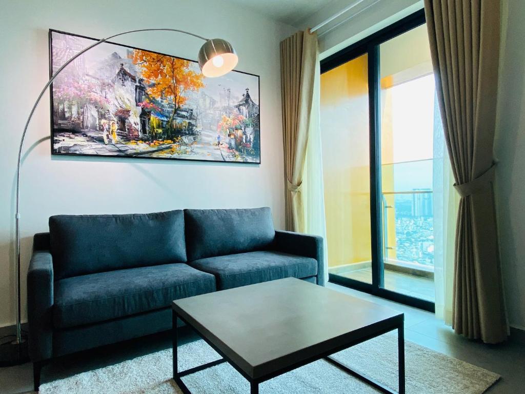 a living room with a couch and a table at 1Br Feliz apartment ThanhMyLoi in Ho Chi Minh City