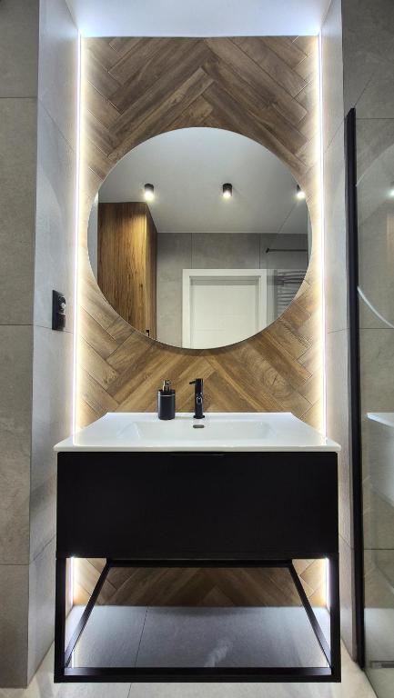 a bathroom with a sink and a mirror at Charming Apartments - Ski Arena Szrenica in Szklarska Poręba
