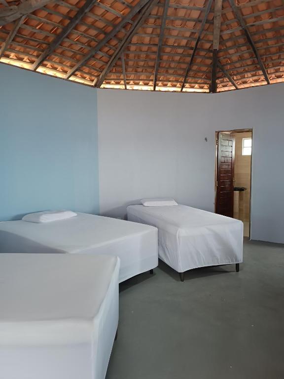 Postel nebo postele na pokoji v ubytování Cabanas del Mar pousada