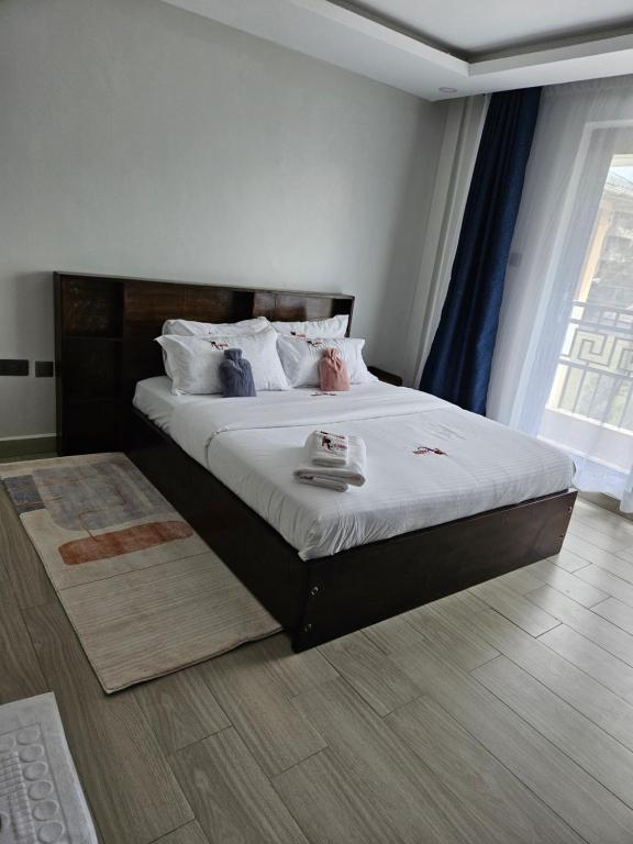 Postel nebo postele na pokoji v ubytování Lumo Residences Eldoret