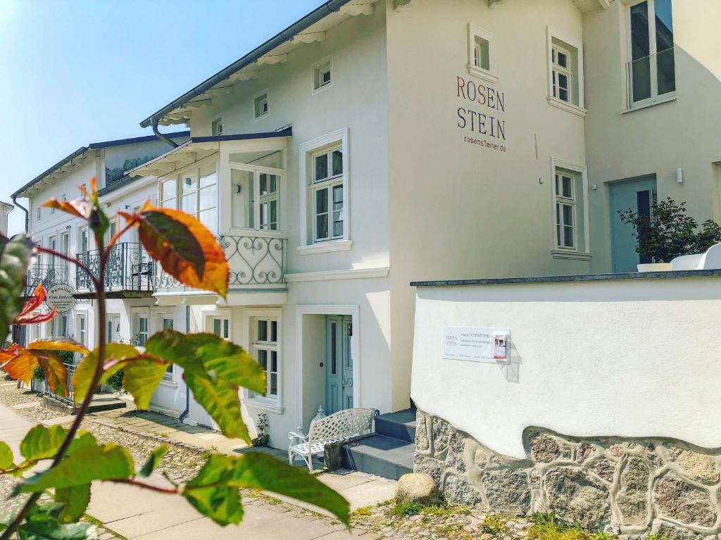 a building with a sign on the side of it at Haus ROSENSTEIN in Sassnitz