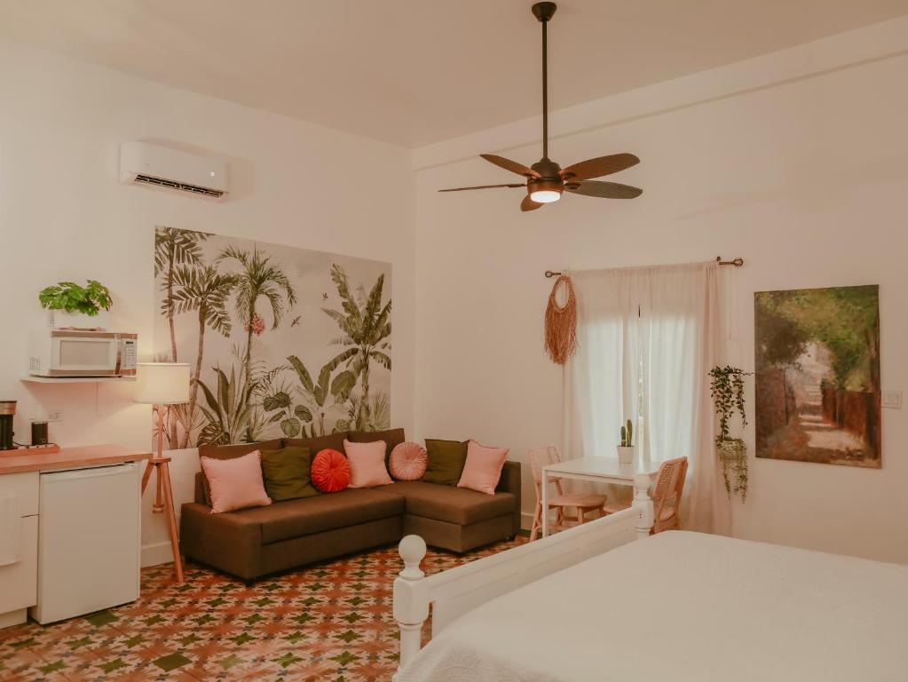 a living room with a bed and a couch at Maison Rouge - Room 2 in Christiansted
