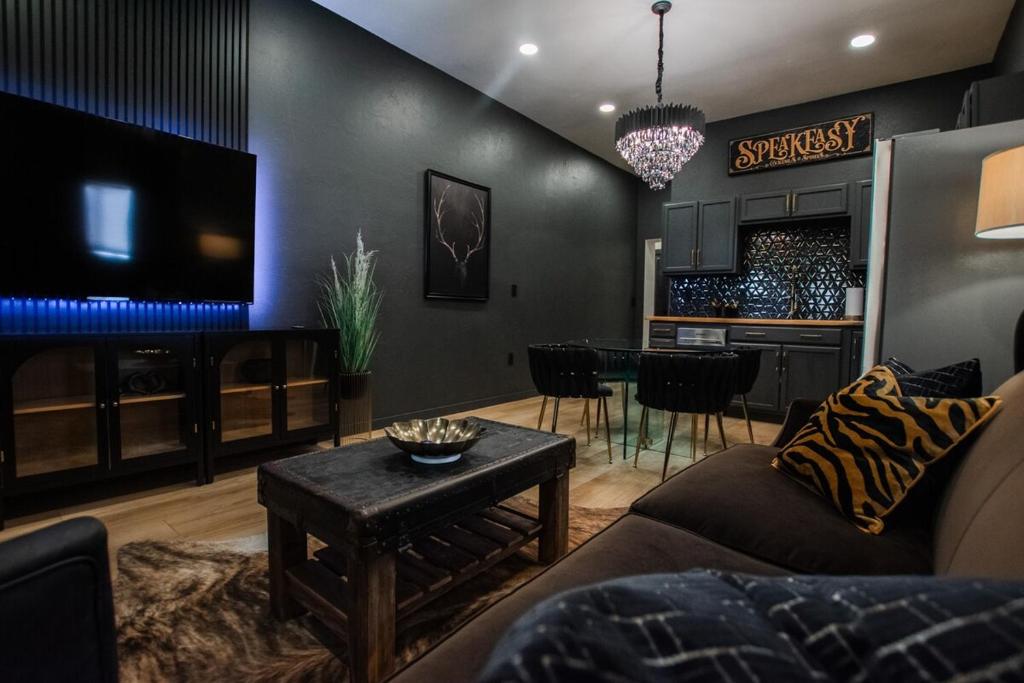 a living room with a couch and a table at Speakeasy Suite at ArnoTriplex-Close to Downtown-Pet Friendly! in Albuquerque