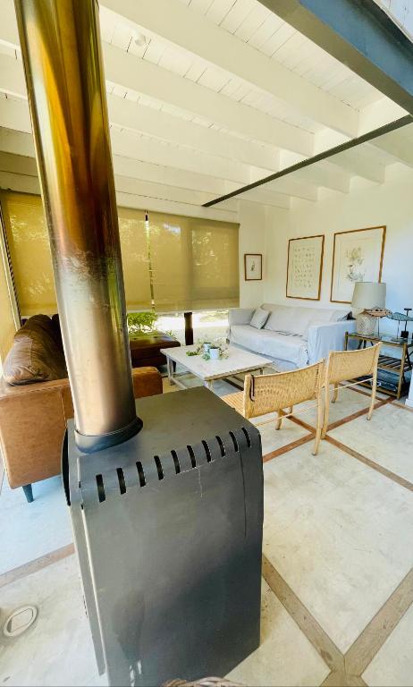 a living room with a wood stove in the middle at Casa en cachagua in Cachagua