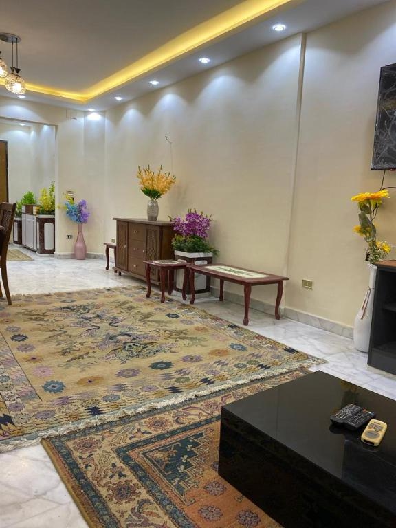 a living room with a large rug and a table at Z m abartment hotel in Giza