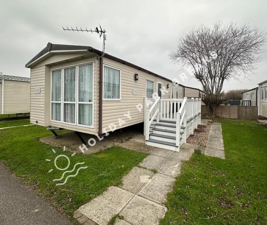a tiny house is parked in a yard at Goldfinch - Spacious 2 bed at Seal Bay in Selsey