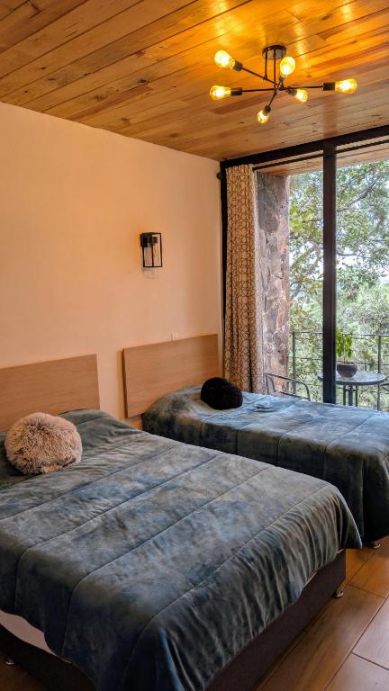 Postel nebo postele na pokoji v ubytování Cabaña La Finca Mazamitla